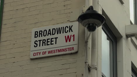 Broadwick-Street-road-sing-close-up-next-to-CCTV-camera,-Soho,-London