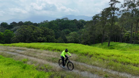 Man-on-Mountain-Bike-riding-uphill-path-in-rainforest-area-of-Dominican-Republic