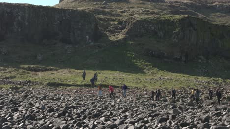 Hand-held-shot-of-a-group-of-tourists-making-their-way-to-the-puffins-on-Lunga