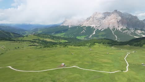 Aerial-tilt-down-view-of-the-lush-green-meadows-of-Pralongia-in-the-Italian-Dolomites