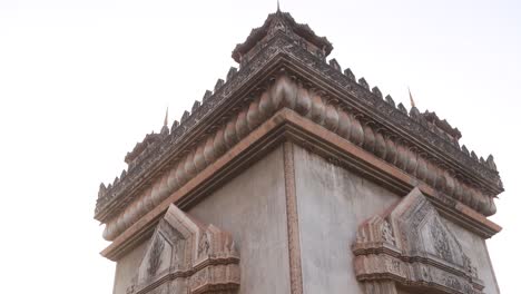 Looking-up-at-the-detailed-intricate-Patuxai-Victory-Monument-in-the-center-of-Vientiane,-Laos