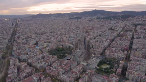 Aerial-of-sunset-in-Barcelona,-capital-of-Spain-with-Sagrada-Familia-from-Gaudi