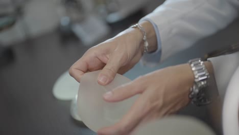 A-Doctor-Showing-Patient-Silicone-Breast-Prosthesis