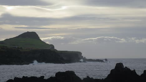 Scenic-Coastal-Volcanic-Island-Cliffs-Landscape-at-Sunset,-Cloudy