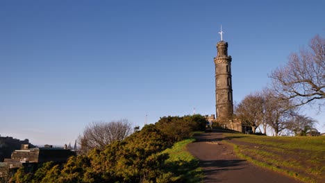 Low-wide-view-of-Nelson-Monument-on-Calton-Hill-on-a-sunny-day,-Edinburgh,-Scotland