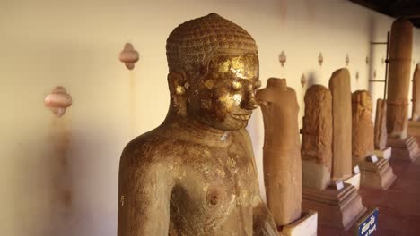 Ancient-buddha-statue-on-the-interior-of-Pha-That-Luang-Golden-Stupa-Buddhist-Temple-in-Vientiane,-Laos