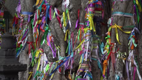 A-tree-twig,-adorned-with-various-colored-ribbons,-gently-sways-in-the-daylight