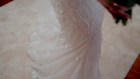 Bride's-lace-wedding-dress-train-trailing-on-carpet