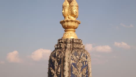 Golden-buddha-face-on-spire-above-Patuxai-Victory-Monument-in-the-center-of-Vientiane,-Laos