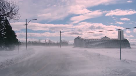 Snow-storm-affecting-visibility-with-road-sign-flapping-with-the-force-of-the-wind