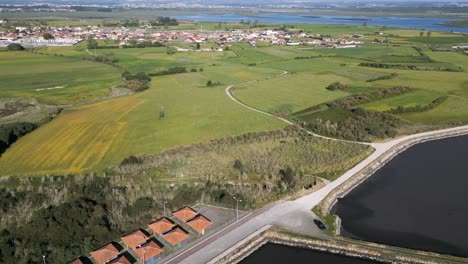 Aerial-view-of-Cais-do-Bico,-fisherman's-sheds-by-a-road-near-Aveiro,-Portugal