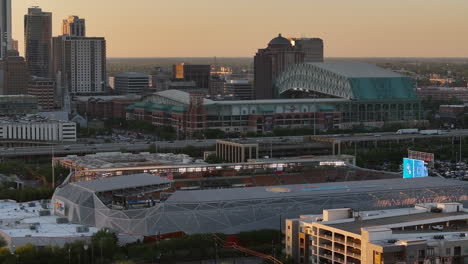 AERIAL-of-the-Shell-Energy-Stadium-and-the-Minute-Maid-Park,-sunrise-in-Houston