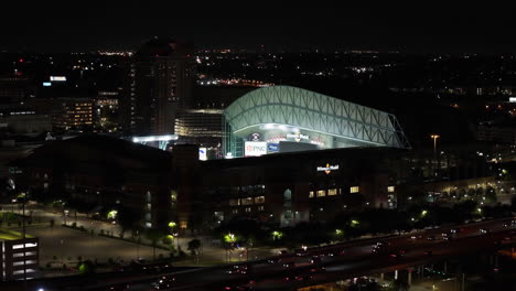 Aerial-view-in-front-of-the-iIlluminated-Minute-Maid-park,-night-in-Houston,-USA