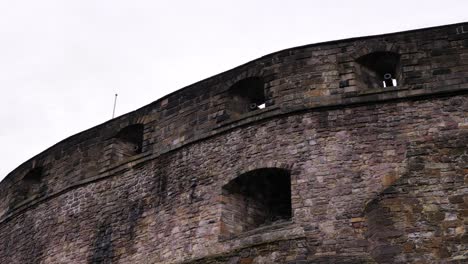 Detailed-shot-of-the-outside-of-Edinburgh-Castle-showing-cannon-holes,-Scotland