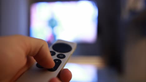 Close-up-shot-of-a-man-utilizing-an-Apple-TV-remote