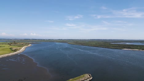 Sweeping-aerial-view-of-Cais-do-Bico-beach-and-estuary,-Murtosa,-Aveiro,-Portugal