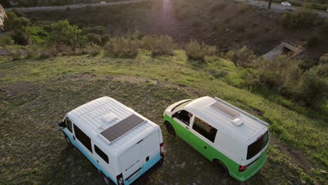 Overhaed-view-of-two-campers-parking-up-at-rest-stop-at-sunset