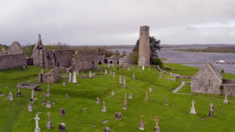 Smooth-aerial-pan-of-Clonmacnoise,,cathedral,-round-towers-and-high-crosses