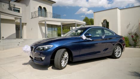 Slow-motion-shot-of-a-wedding-car-ready-to-go-with-white-ribbons