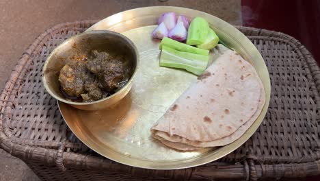 Shot-of-Roti-and-mutton-served-in-brass-plate