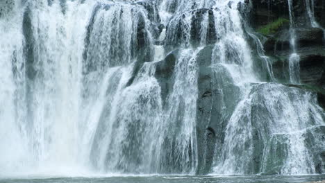 A-waterfall-cascades-in-a-tropical-rainforest-with-rock