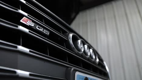 Close-Up-Tracking-of-Audi's-Silver-Emblem-on-Black-Grill