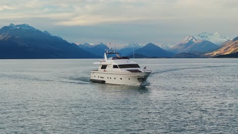 Medium-aerial-orbit-around-front-edge-of-yacht-tour-cruise-in-Lake-Wakatipu