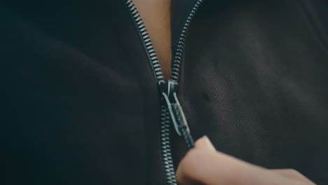 Woman-pulling-down-jacket-zipper-in-extreme-slow-motion,-close-up-4k-800fps-taking-off-hoodie