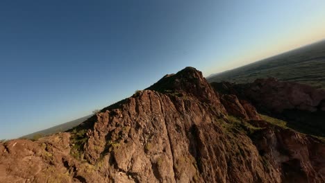 Aerial-FPV-Flying-Over-Sandstone-Cliffs-In-Arizona-Desert-With-Flock-Of-Birds-Soaring-Past-During-Sunset