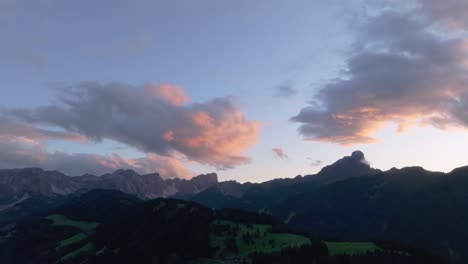 Cinematic-sunset-aerial-tilt-down-view-of-the-Sass-de-Putia-in-cloud-kissed-Dolomites