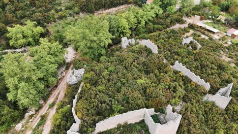 Aerial-View-of-the-Ruins-of-the-Ancient-Roman-Kadrema-Castle-Located-in-the-Gedelme-Village-and-Mountain-Ridge-on-Background