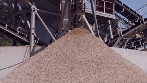 Pouring-gravel-from-conveyor:-a-seamless-flow-of-yellow-stones