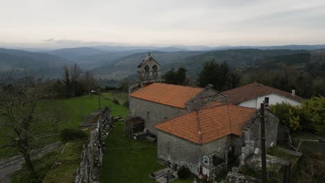 Serene-San-Fiz-de-Navío-Church-in-lush-Galician-landscape,-San-Amaro,-Spain---aerial