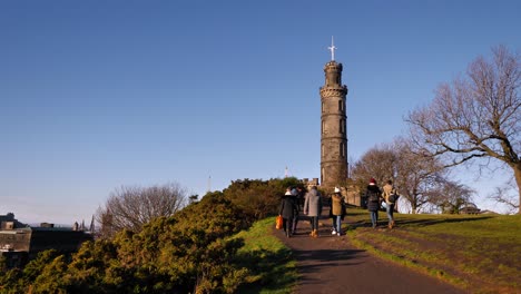 People-walking-along-a-path-to-the-top-of-Calton-Hill,-Edinburgh,-Scotland