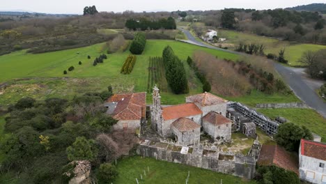 Aerial-view-of-Santa-Uxia-de-Eiras-Church,-lush-Galician-surrounds,-San-Amaro