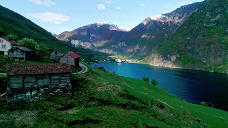 Aerial-Flam-village-Norway-fjord-shore-mountains-valley-snow-peak-nature