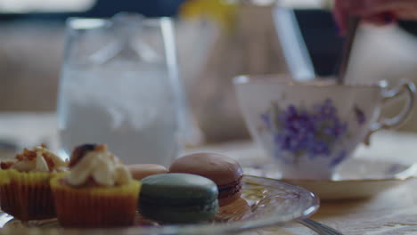 Panning-across-table-as-the-tea-is-stirred-to-reveal-a-beautiful-plate-of-pastries