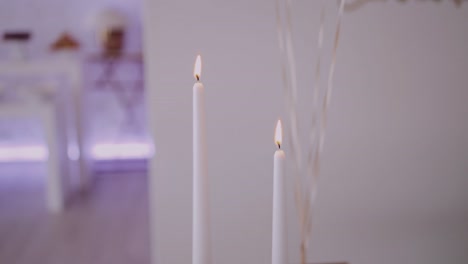 Close-up-of-lit-candles-with-a-soft-glow,-conveying-warmth-and-tranquility