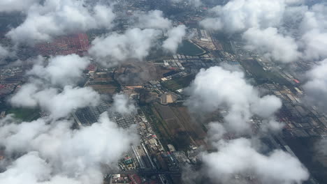 An-aerial-view-of-the-clouds-and-cityscape-below-the-clouds