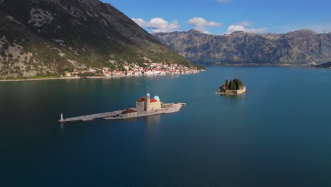 4K-drone-footage-captures-Our-Lady-of-the-Rocks-and-Saint-George-islands-in-the-beautiful-UNESCO-listed-Bay-of-Kotor,-Montenegro