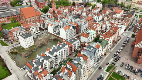 Aerial-establishing-shot-of-medieval-old-town-with-ancient-architectural-polish-style-buildings