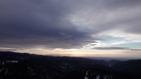 A-dramatic-sunset-with-beautiful-clouds-over-the-mountains-near-Cloudcroft,-New-Mexico,-aerial-view