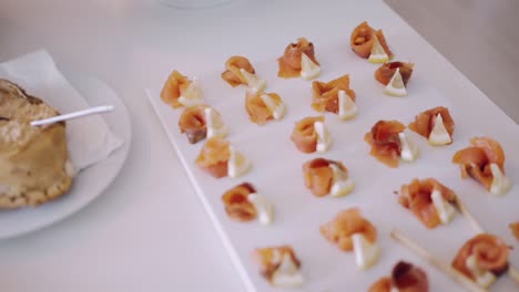 Delicate-smoked-salmon-and-cheese-appetizers-on-white-plate