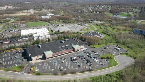 4K-Aerial-Drone-footage-of-industrial-shopping-centers-and-strip-malls-in-Middletown-New-York-and-traffics-can-be-seen-with-mountains-in-the-background