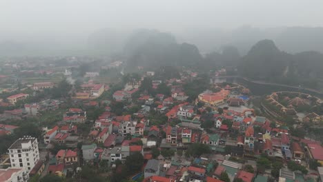 Vietnams-Provinz-Ninh-Binh:-Nebliges-Luftbild-Einer-Drohne-Von-Gebäuden-Und-Einem-Haus-In-Der-Nähe-Von-Hügeln