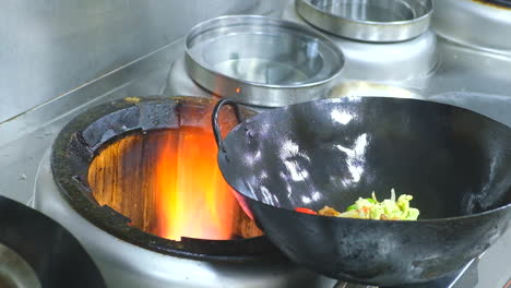 Professional-Chef-Fires-Up-Oil-On-A-Pan-In-A-Commercial-Kitchen-Restaurant