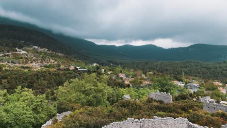 Aerial-View-of-the-Ruins-of-the-Ancient-Roman-Kadrema-Castle-Located-in-the-Gedelme-Village-and-Mountain-Ridge-on-Background