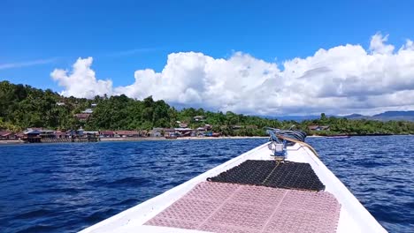 Boat-drives-in-the-sea-waters-on-Karampuang-Island,-Mamuju,-West-Sulawesi,-Indonesia