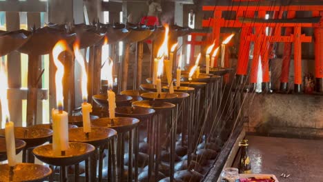 Lit-candles-and-flames-in-Fushimi-Inari-Taisha-in-Japan