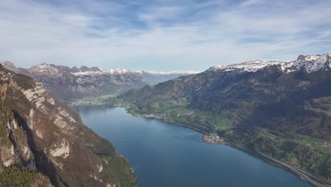 Breath-taking-bird's-eye-view-of-Lake-Walensee-in-the-Swiss-Alps,-surrounded-by-quaint-villages-and-imposing-mountains